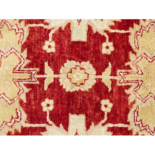 1335 - Carpet / Rug : A red ground rug with cream beige borders and floral and foliate detail. ' Palazzo Qu... 