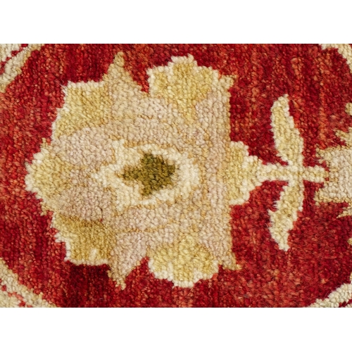 1335 - Carpet / Rug : A red ground rug with cream beige borders and floral and foliate detail. ' Palazzo Qu... 