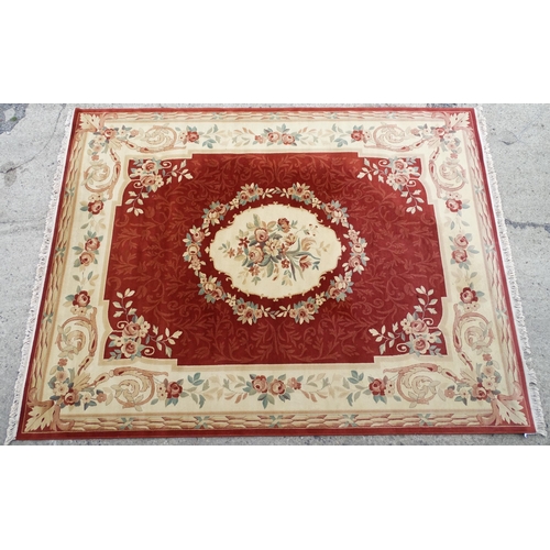 1336 - Carpet / Rug : A red ground rug with central floral vignette and garland with foliate detail with cr... 