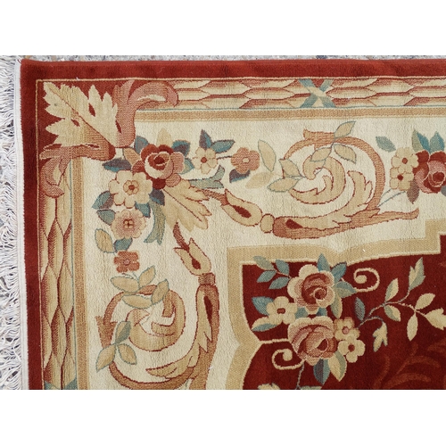 1336 - Carpet / Rug : A red ground rug with central floral vignette and garland with foliate detail with cr... 