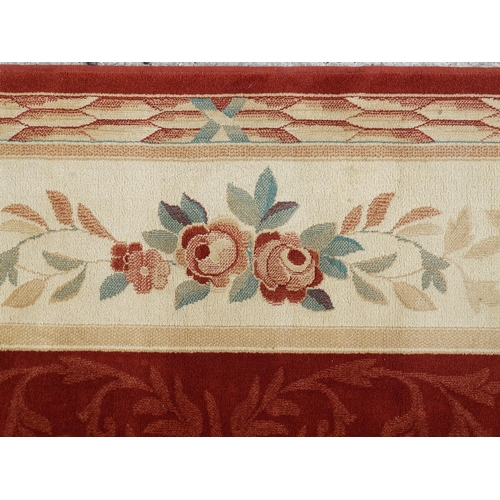 1336 - Carpet / Rug : A red ground rug with central floral vignette and garland with foliate detail with cr... 