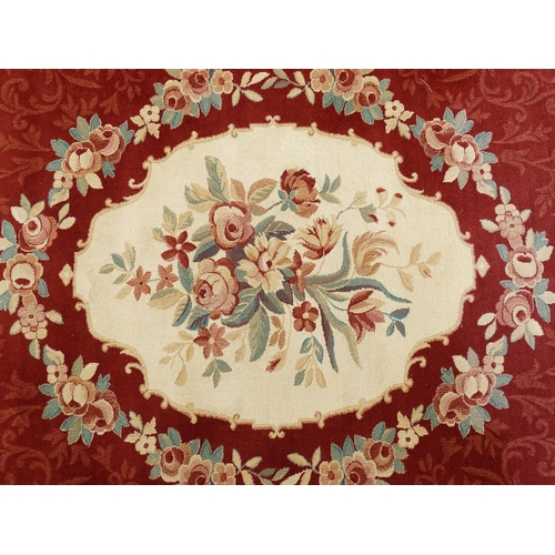 1336 - Carpet / Rug : A red ground rug with central floral vignette and garland with foliate detail with cr... 