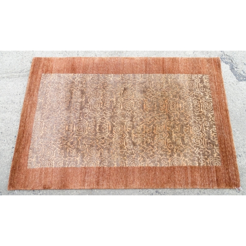 1337 - Carpet / Rug : A Nepalese woollen hand knotted rug worked in terracotta, taupe and beige. Approx. 70... 