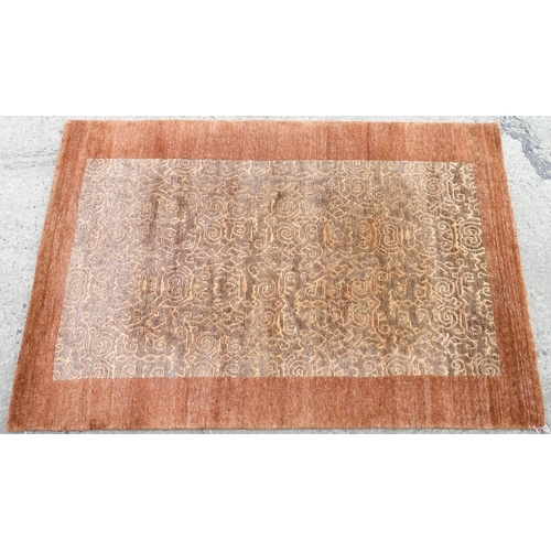 1337 - Carpet / Rug : A Nepalese woollen hand knotted rug worked in terracotta, taupe and beige. Approx. 70... 