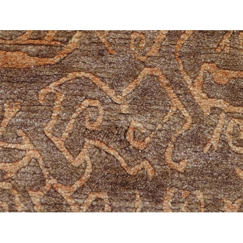 1337 - Carpet / Rug : A Nepalese woollen hand knotted rug worked in terracotta, taupe and beige. Approx. 70... 