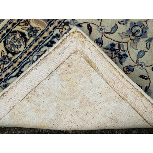 1338 - Carpet / Rug : A beige ground runner with floral and foliate detail worked in shades of blue.  Appro... 