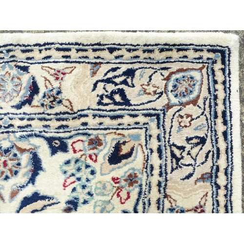 1338 - Carpet / Rug : A beige ground runner with floral and foliate detail worked in shades of blue.  Appro... 