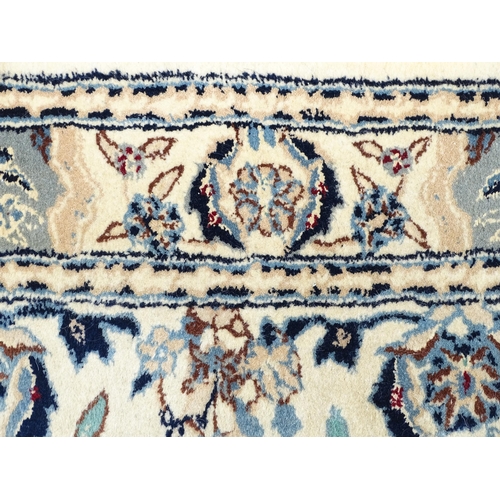 1338 - Carpet / Rug : A beige ground runner with floral and foliate detail worked in shades of blue.  Appro... 