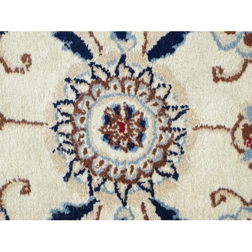 1338 - Carpet / Rug : A beige ground runner with floral and foliate detail worked in shades of blue.  Appro... 