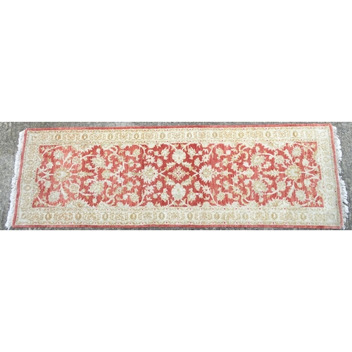 1339 - Carpet / Rug : A salmon red ground Runner  with beige border, decorated with floral and foliate deta... 