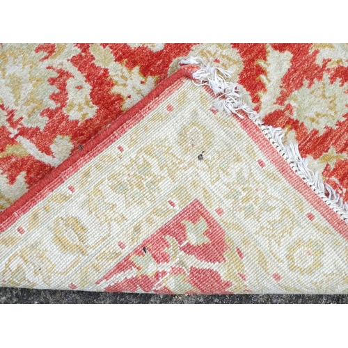 1339 - Carpet / Rug : A salmon red ground Runner  with beige border, decorated with floral and foliate deta... 