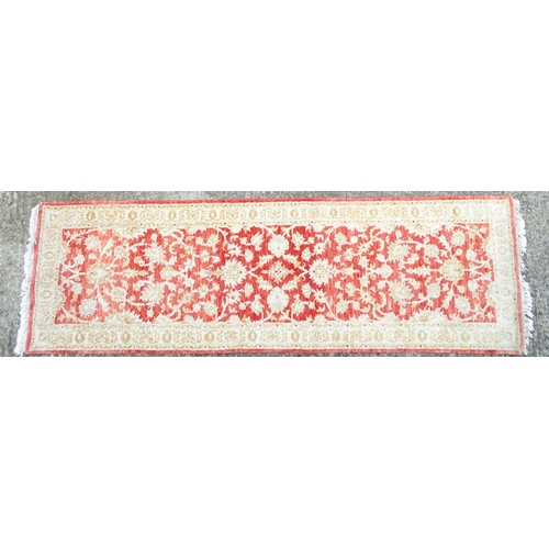 1339 - Carpet / Rug : A salmon red ground Runner  with beige border, decorated with floral and foliate deta... 