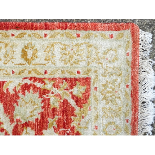 1339 - Carpet / Rug : A salmon red ground Runner  with beige border, decorated with floral and foliate deta... 