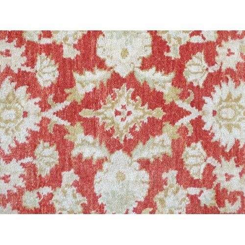 1339 - Carpet / Rug : A salmon red ground Runner  with beige border, decorated with floral and foliate deta... 