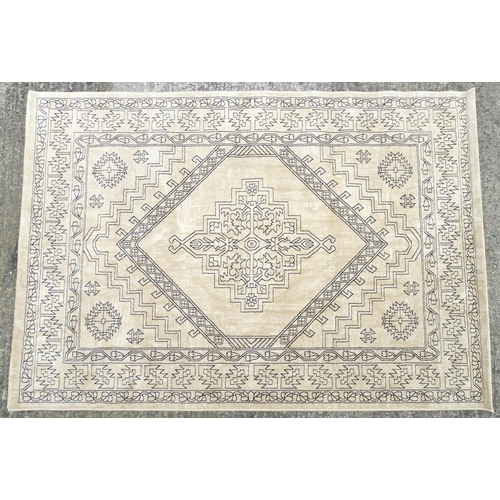 1340 - Carpet / Rug : A cream ground rug with dark geometric detail.  Approx. 92