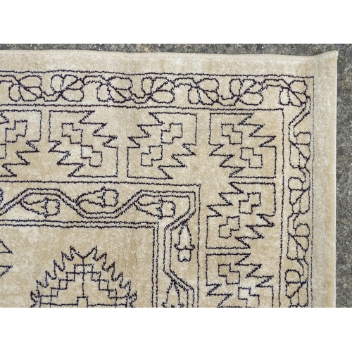 1340 - Carpet / Rug : A cream ground rug with dark geometric detail.  Approx. 92