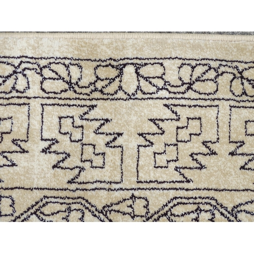 1340 - Carpet / Rug : A cream ground rug with dark geometric detail.  Approx. 92