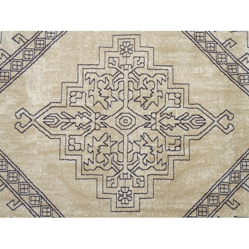 1340 - Carpet / Rug : A cream ground rug with dark geometric detail.  Approx. 92