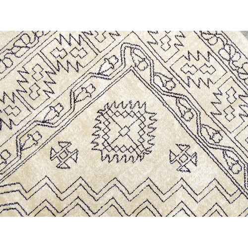 1340 - Carpet / Rug : A cream ground rug with dark geometric detail.  Approx. 92