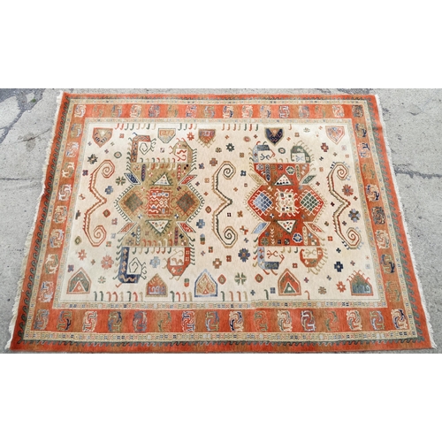 1341 - Carpet / Rug : A cream ground rug with dark salmon / terracotta borders, decorated with geometric an... 