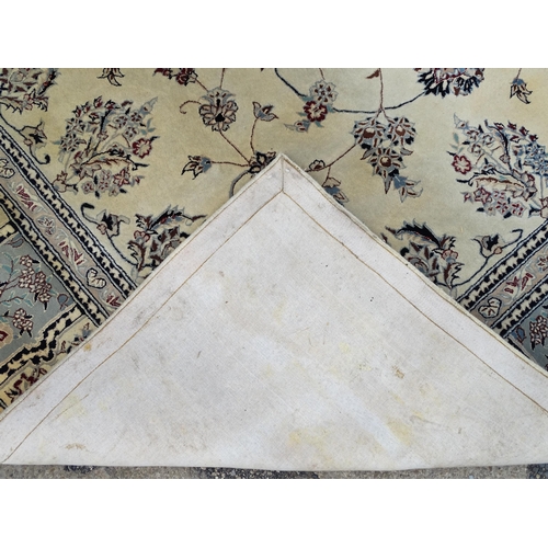 1342 - Carpet / Rug : A beige ground rug with floral and foliate detail worked in shades of blue.  Approx. ... 