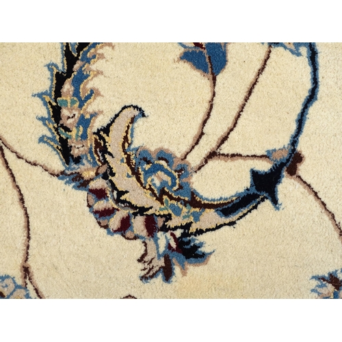 1342 - Carpet / Rug : A beige ground rug with floral and foliate detail worked in shades of blue.  Approx. ... 