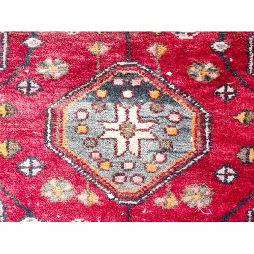 1344 - Carpet / Rug : A rug with red and cream ground decorated with geometric motifs and stylised birds an... 