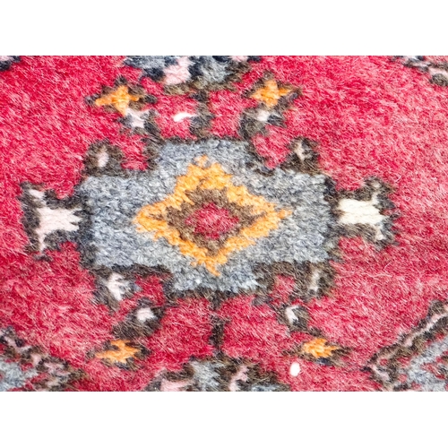 1344 - Carpet / Rug : A rug with red and cream ground decorated with geometric motifs and stylised birds an... 