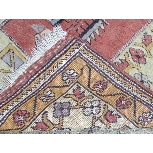 1345 - Carpet / Rug : A rug with salmon and cream grounds with geometric and floral detail and mustard bord... 