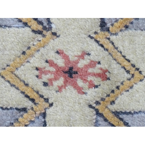 1345 - Carpet / Rug : A rug with salmon and cream grounds with geometric and floral detail and mustard bord... 