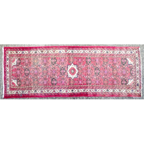 1349 - Carpet / Rug : A runner with pink red grounds decorated with floral foliate and geometric motifs  Ap... 