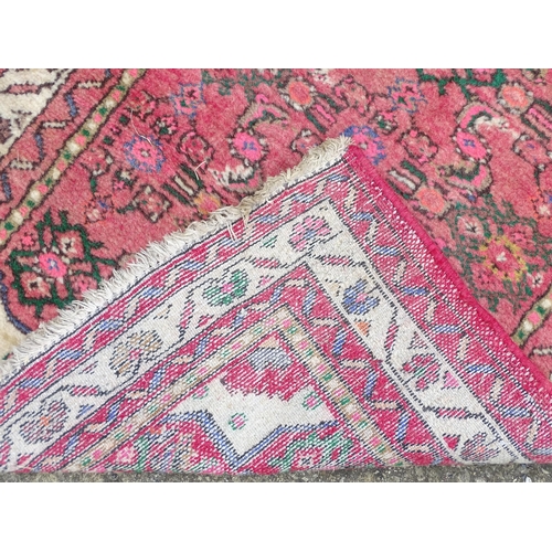 1349 - Carpet / Rug : A runner with pink red grounds decorated with floral foliate and geometric motifs  Ap... 