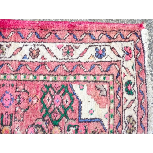 1349 - Carpet / Rug : A runner with pink red grounds decorated with floral foliate and geometric motifs  Ap... 