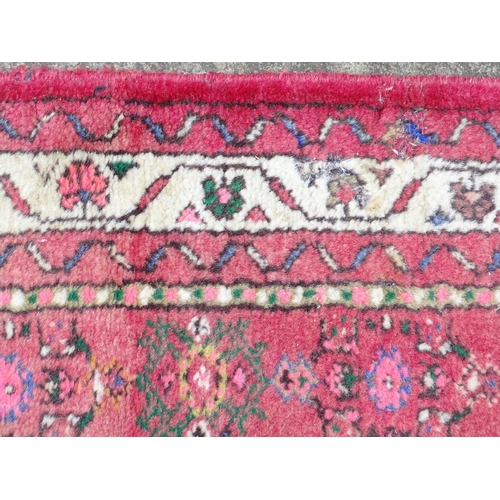 1349 - Carpet / Rug : A runner with pink red grounds decorated with floral foliate and geometric motifs  Ap... 