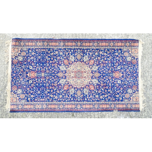 1351 - Carpet / Rug : A blue ground rug with central roundel motiff and floral and foliate detail. Approx. ... 