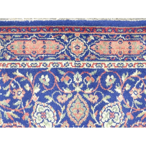 1351 - Carpet / Rug : A blue ground rug with central roundel motiff and floral and foliate detail. Approx. ... 