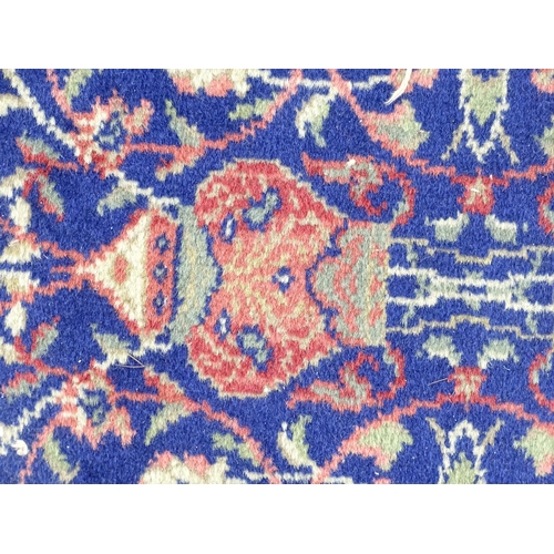 1351 - Carpet / Rug : A blue ground rug with central roundel motiff and floral and foliate detail. Approx. ... 