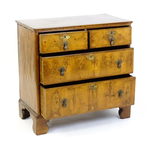 1450 - An 18thC walnut chest of drawers with a moulded and crossbanded top above two short over three long ... 