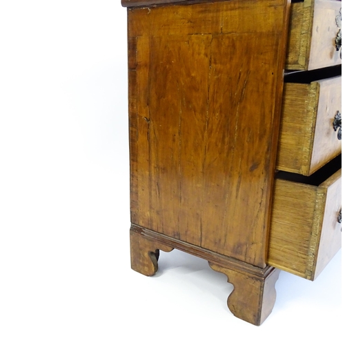 1450 - An 18thC walnut chest of drawers with a moulded and crossbanded top above two short over three long ... 