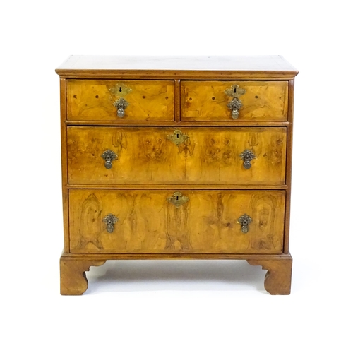 1450 - An 18thC walnut chest of drawers with a moulded and crossbanded top above two short over three long ... 