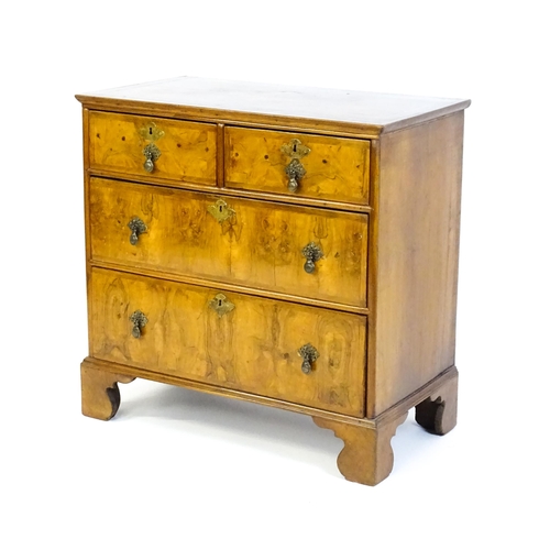 1450 - An 18thC walnut chest of drawers with a moulded and crossbanded top above two short over three long ... 