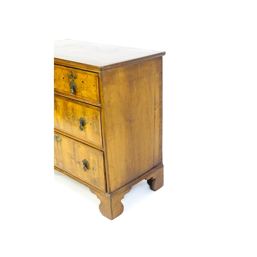 1450 - An 18thC walnut chest of drawers with a moulded and crossbanded top above two short over three long ... 