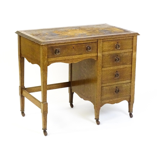 1478 - An Arts & Crafts oak desk, with an inset leather top above a bank of four graduated drawers and one ... 