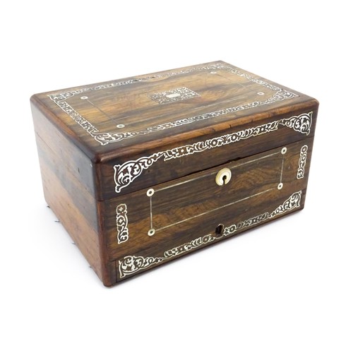 1087 - A Victorian rosewood workbox with drawer under, the exterior decorated with mother of pearl inlay. A... 