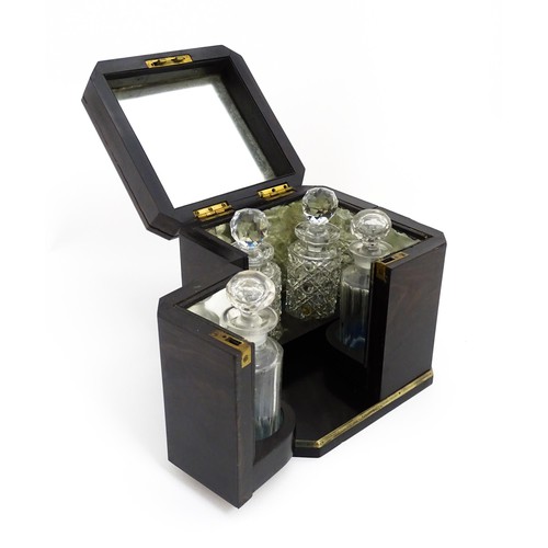 1101 - A Victorian ebonised dressing table cabinet opening to reveal a mirrored interior with four associat... 