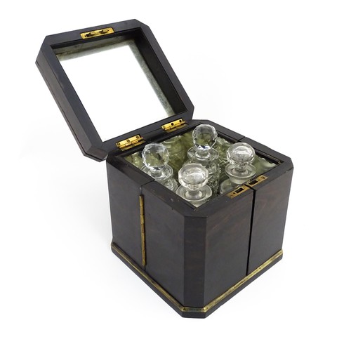 1101 - A Victorian ebonised dressing table cabinet opening to reveal a mirrored interior with four associat... 