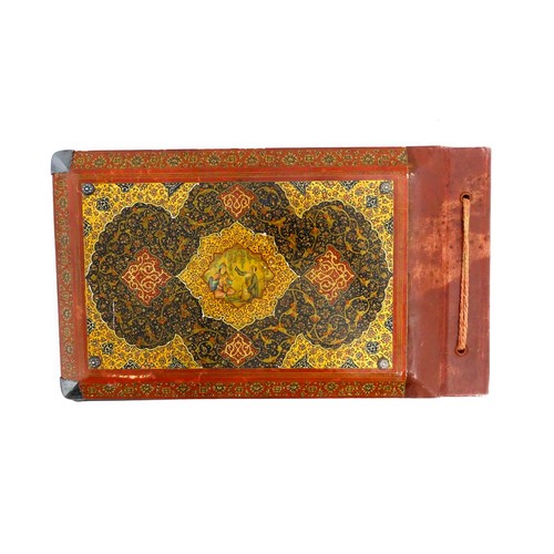 1114 - A Persian photograph album with lacquered boards decorated with a hand painted panel depicting a cou... 