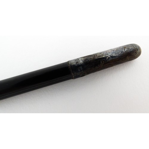 1118 - An early 20thC ebonised conductor's baton of tapering form with silver mounts engraved with foliate ... 