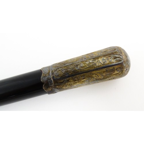 1118 - An early 20thC ebonised conductor's baton of tapering form with silver mounts engraved with foliate ... 