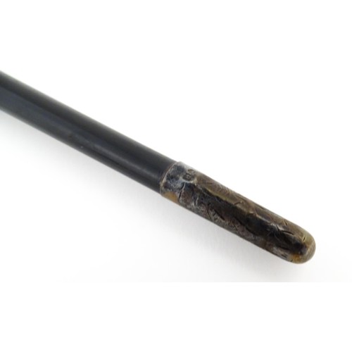 1118 - An early 20thC ebonised conductor's baton of tapering form with silver mounts engraved with foliate ... 